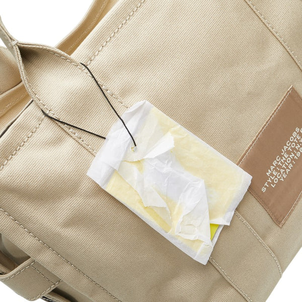 マークジェイコブス ザ ミディアム トラベラー グラフィック トートバッグ ベージュ ホワイト キャンバス レディース MARC JACOBS 【中古】